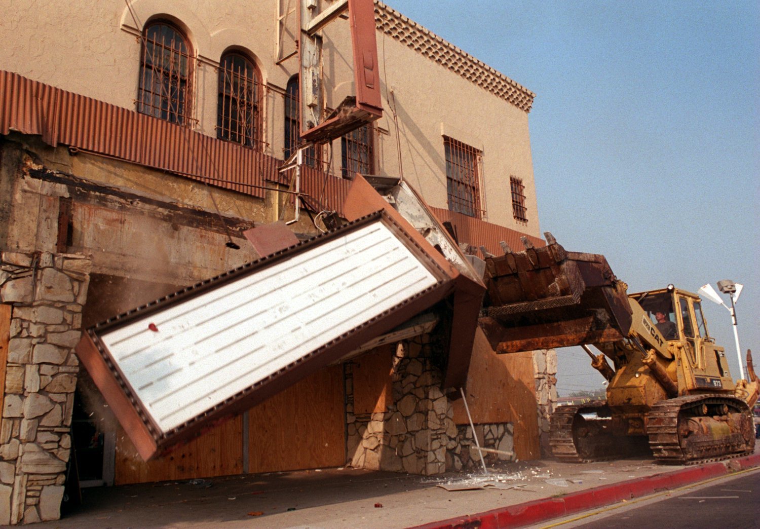 a bulldozer knocks down the marquee of the pussycat theater in buena park in after