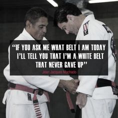 a humble jean jacques machado receives his red black belt from rickson gracie