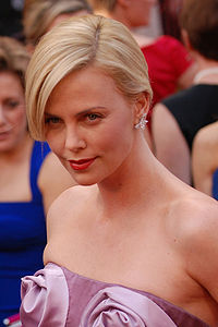 a photograph of theron on the red carpet at the academy awards
