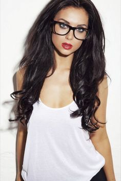 attractive woman wearing bi focal glasses with extremely long curly black hair street style