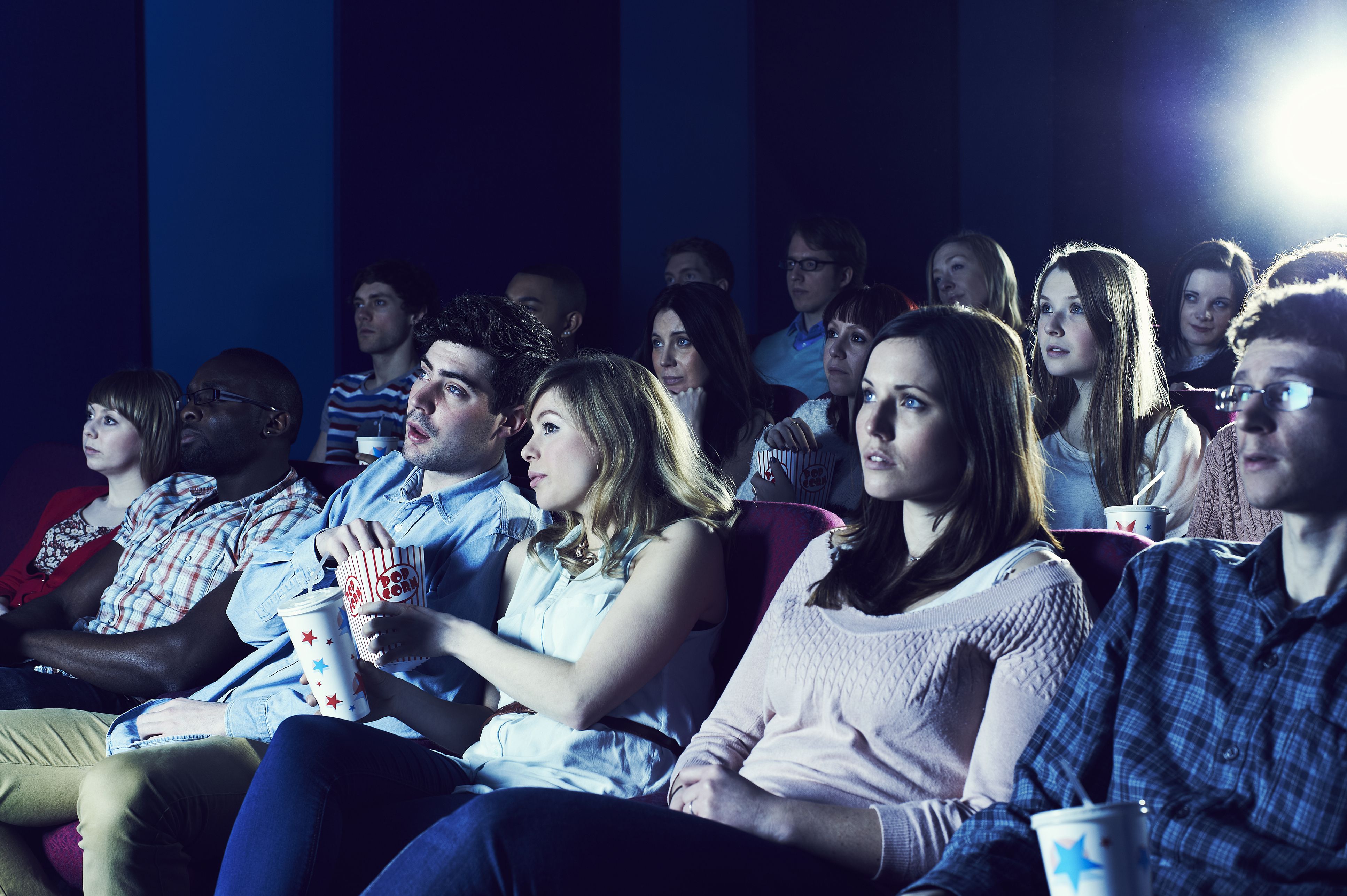 audience enjoying movie at the cinema e abed