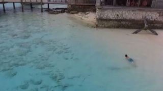 boy narrowly escapes sharks in shallow waters of bahamas drone video is intense