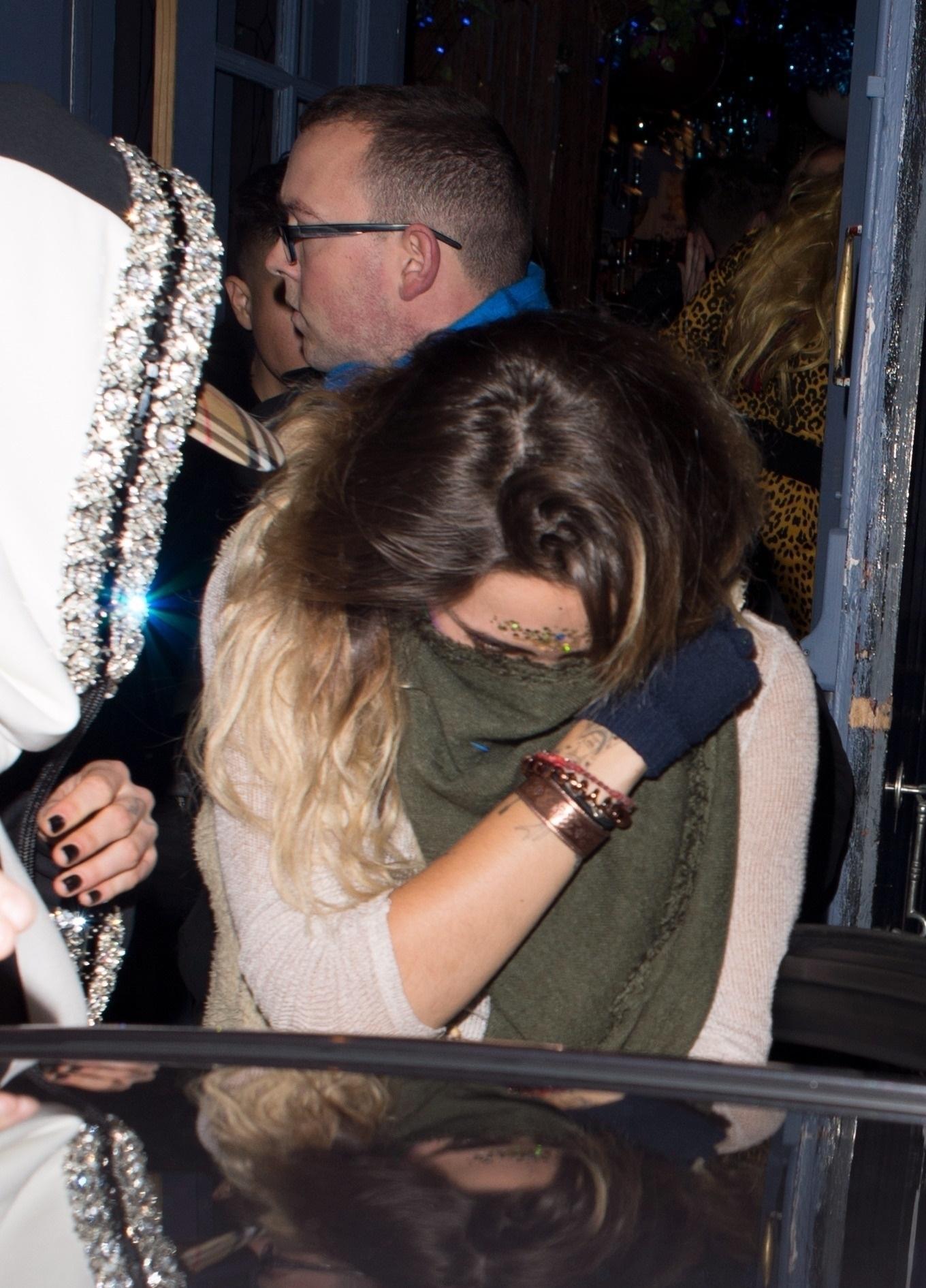 cara delevingne sneaks out of a fire escape door hand in hand with