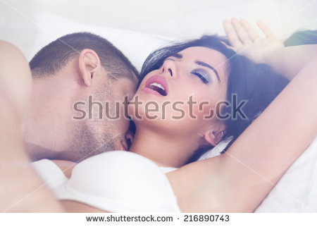 couple lying laptop bed watching porn stock photo 3