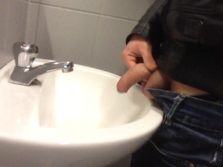 dirty young boy pissing in public sink