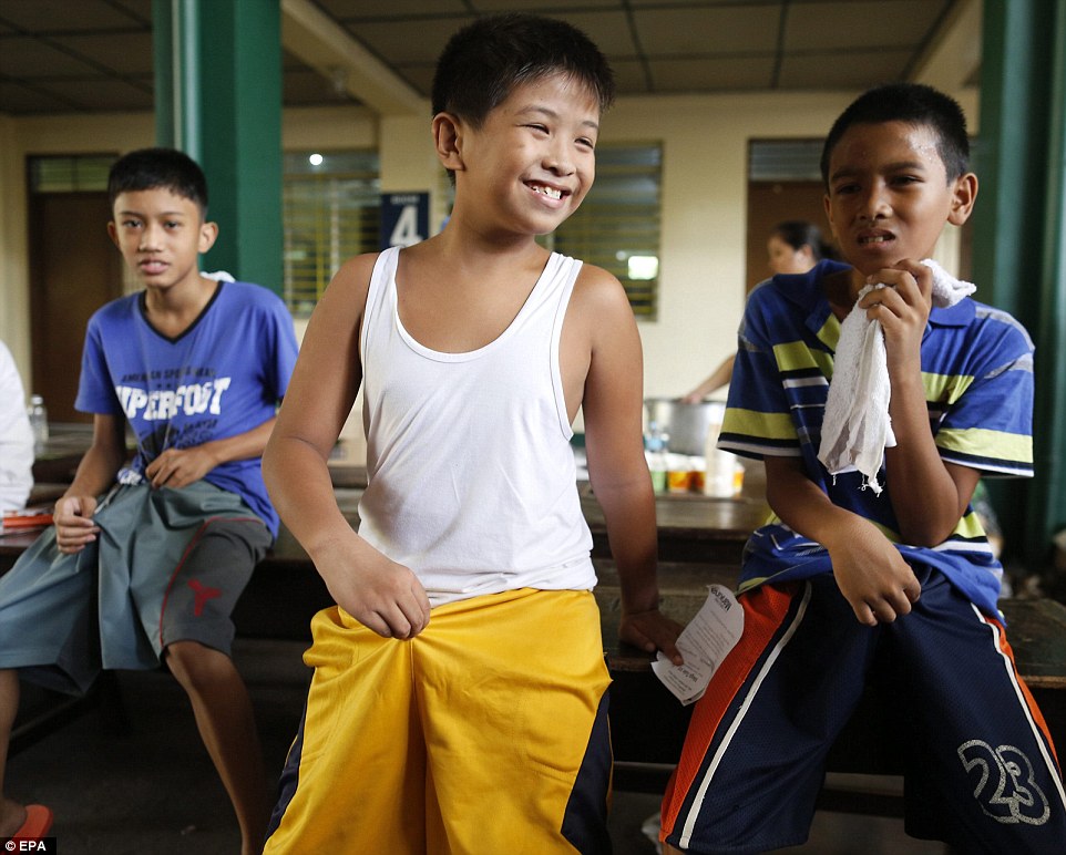glad thats over a filipino boy beams with delight when the circumcision operation is completed