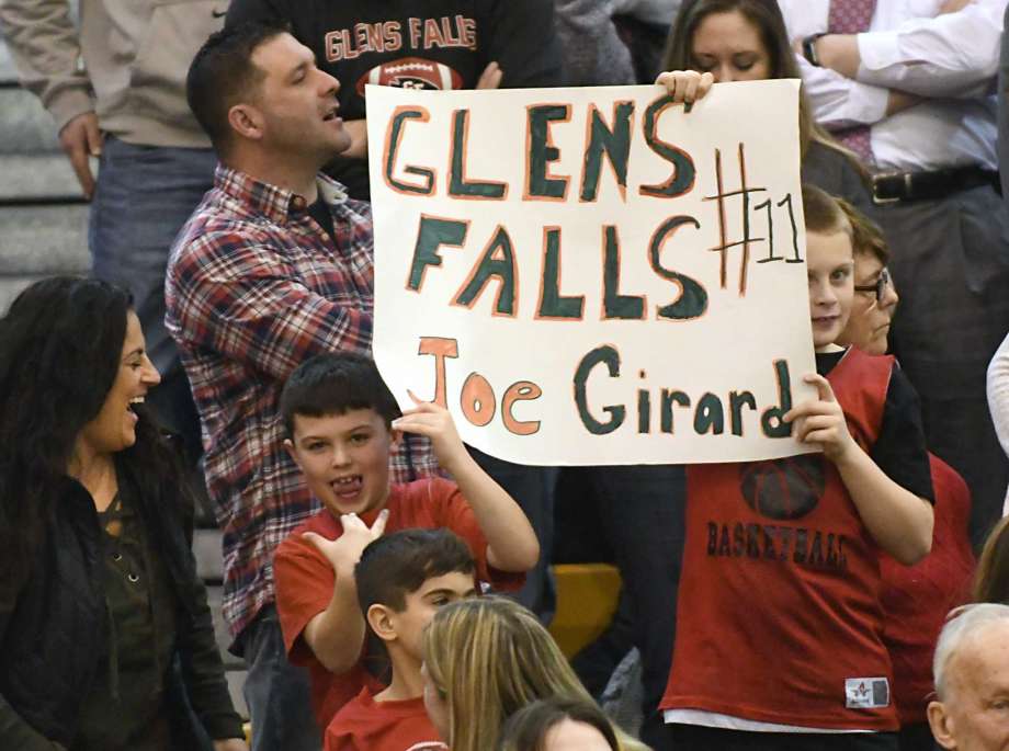 glens falls joseph girard iii fans hold up a sign during a basketball game against