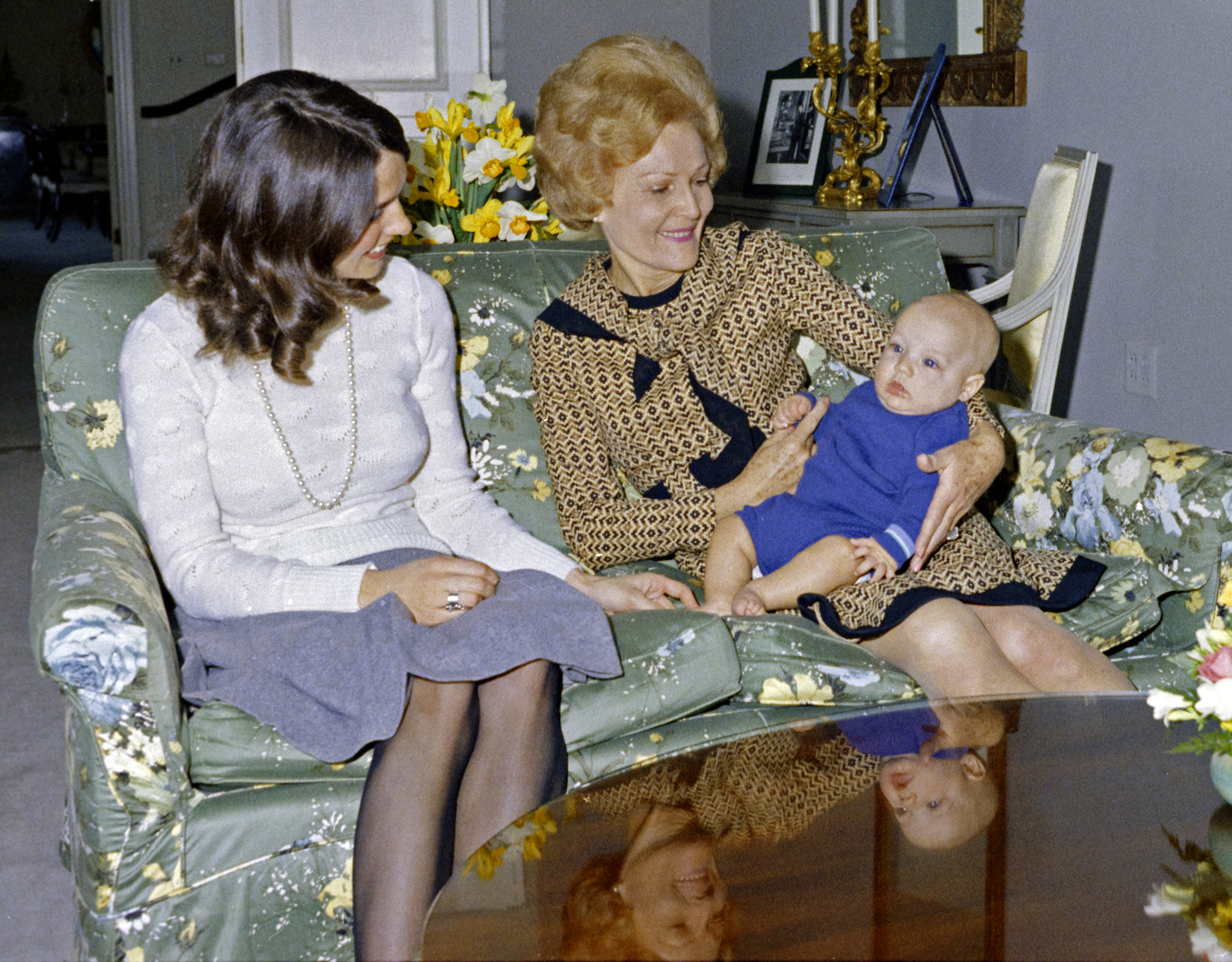 holding month old future canadian prime minister justin trudeau as his mother looks on april