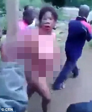 horrific footage shows a female self confessed child kidnapping witch doctor stripped