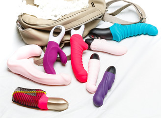 many watches female vibrators with a bag on white background