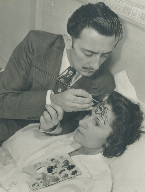 on his wifes forehead salvador dali paints the head of medusa one of the three snaky haired gorgo