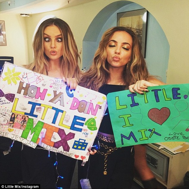 poster girls jade added a picture of her and perrie holding up homemade banners