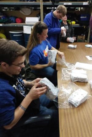 program participants and staff from fort collins based ability in motion help wrap diapers