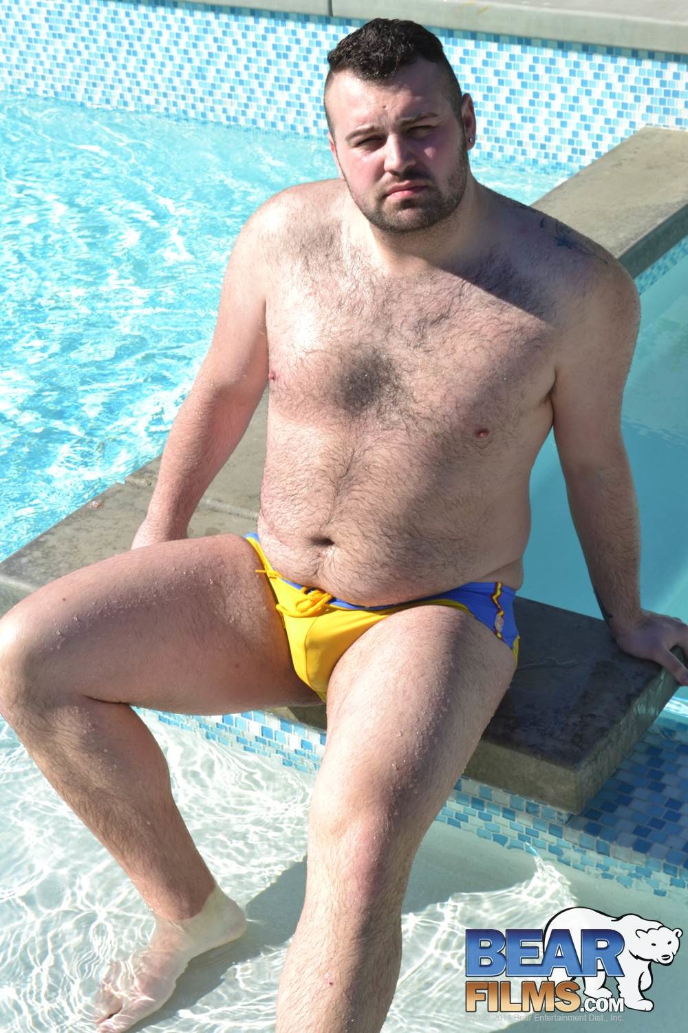 rex blue poses in a speedo for gay porn site bear films
