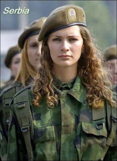 soldier young beautiful girl dressed in a camouflage with a gun