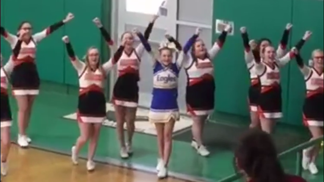 squad joins sole cheerleader from opposing school who was cheering alone
