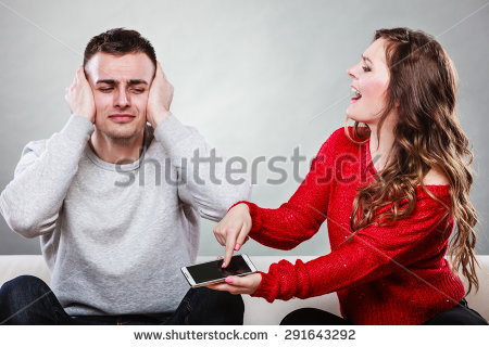 stock photo angry furious wife shouting at husband showing text messages from lover mistress on his mobile