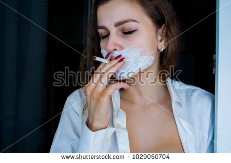 stock photo beautiful young woman with blue eyes in a man shirt with a shaving foam on her face and cigarette 1