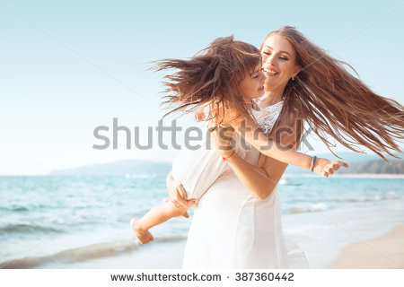 stock photo family walking on the evening beach during sunset child with mom