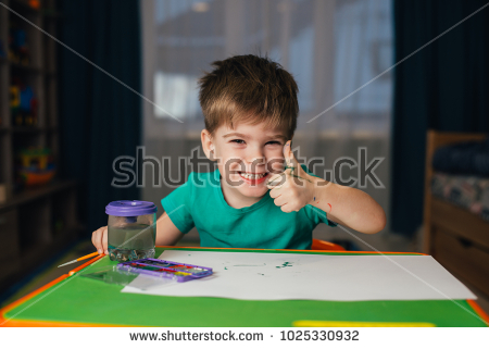 stock photo little boy draws a brush and paint his first picture focus at the drawing