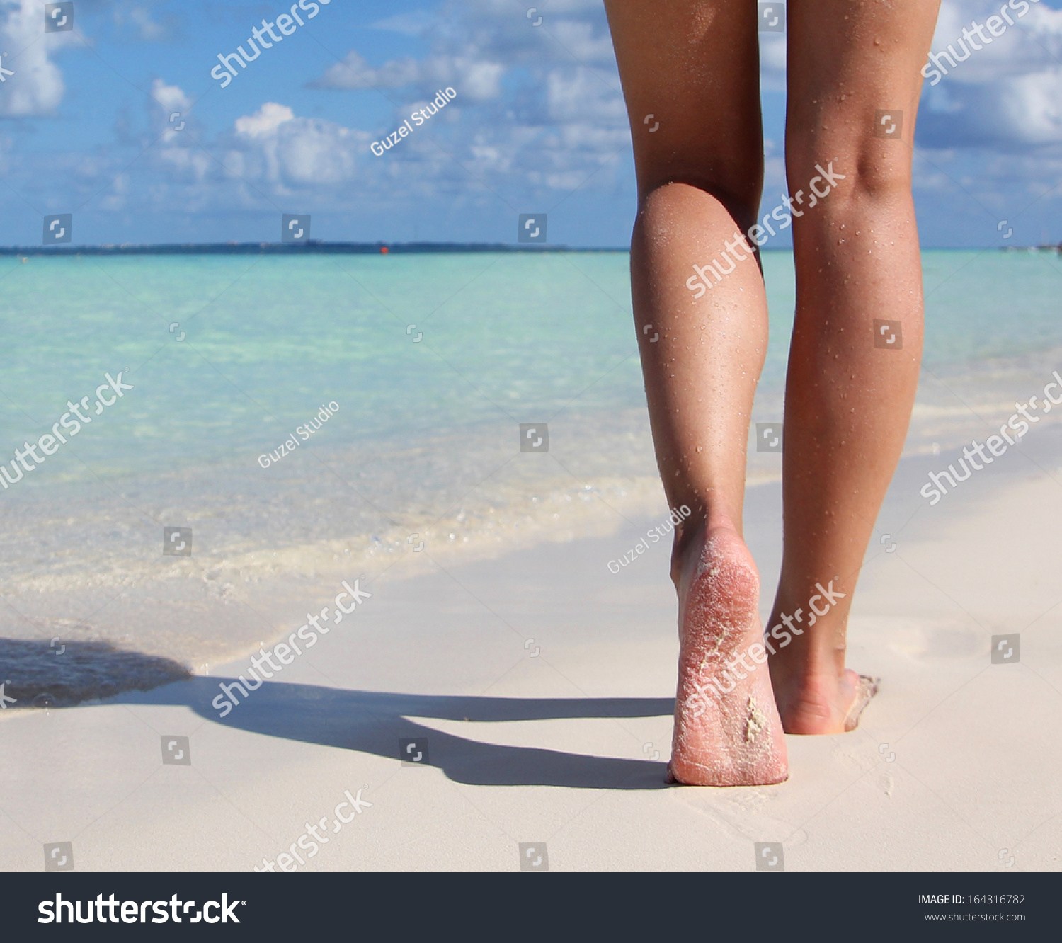 stock photo sexy legs on tropical sand beach walking female feet closeup