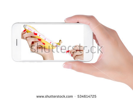 stock photo woman using her smart phone searching sexy hand and measuring tape wrapped on banana men health