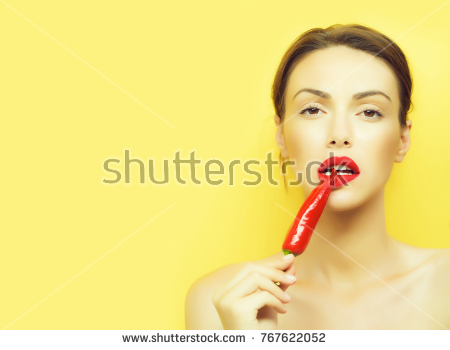 stock photo young cute woman or girl portrait with red chilli pepper in sexy lips on pretty face and brunette