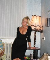 tanned blonde milf shows her body in a tight dress