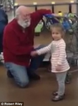 the little girl thinks the bearded old man in the shopping mall is santa claus