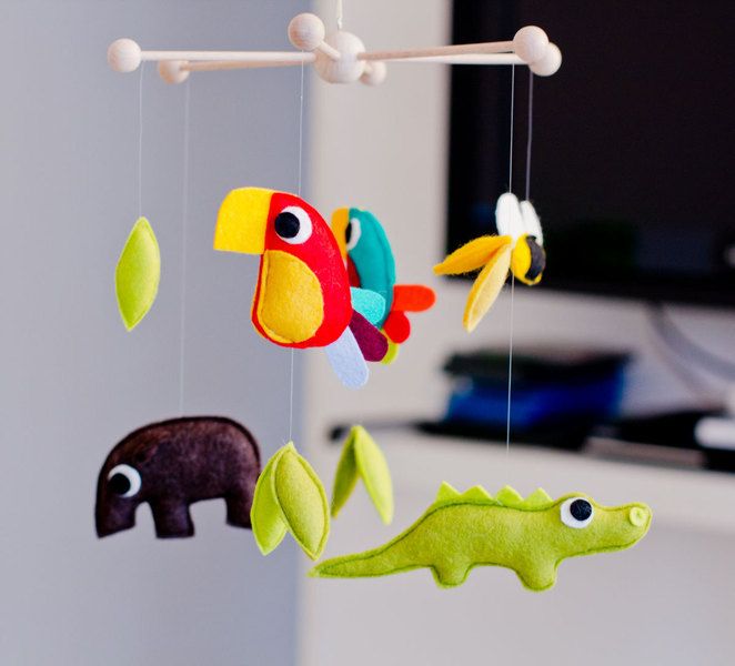 this hanging mobile contains plushies that include tapir birds bee crocodile