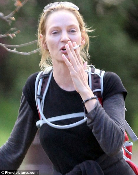 uma thurman risks fine as she lights up illegally in a public