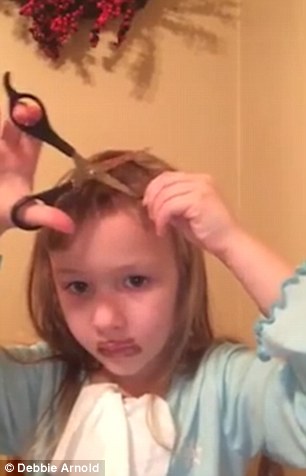 video shows young girl attempting to cut her own hair