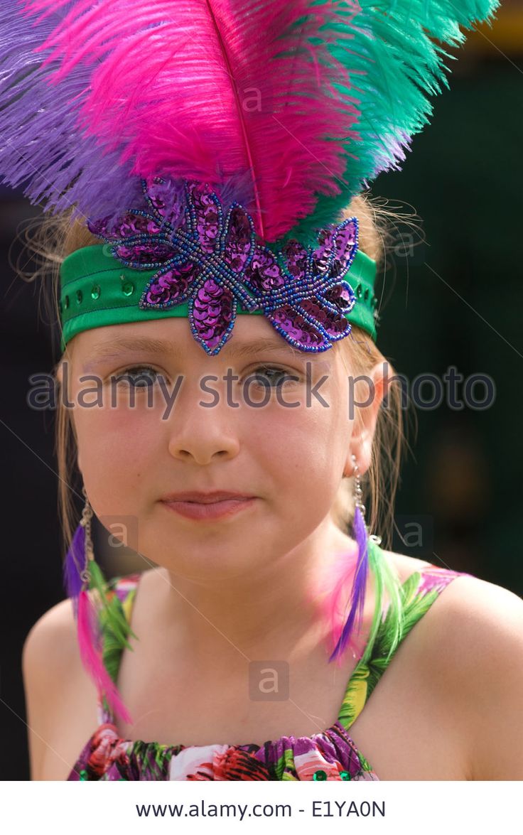year old girl wearing brazilian carnival costume at a village summer fair which had