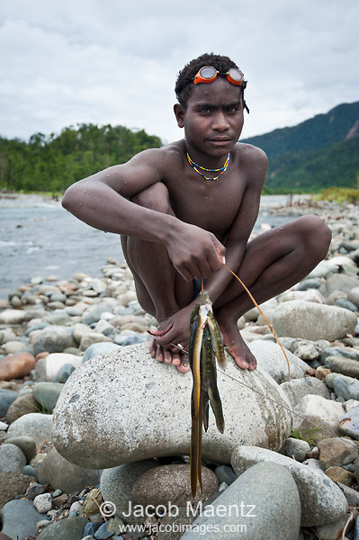 young agta man with his fish catch the agta and dumagat are a subgroup of the aeta people
