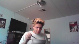 young blonde college student eats fruit loops on webcam