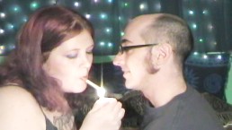 young french kissing her man while smoking
