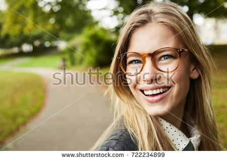 young woman wearing glasses laughing fall stock photo